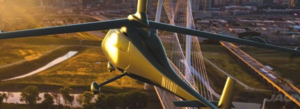 A green helicopter flies over a city bridge at sunset, with urban buildings and a river visible below.