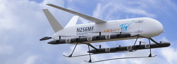 A white experimental cargo drone labelled MightyFly and N256MF flies against a cloudy sky.