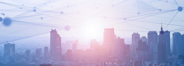 A city skyline at sunrise with digital network lines and nodes overlying the scene.
